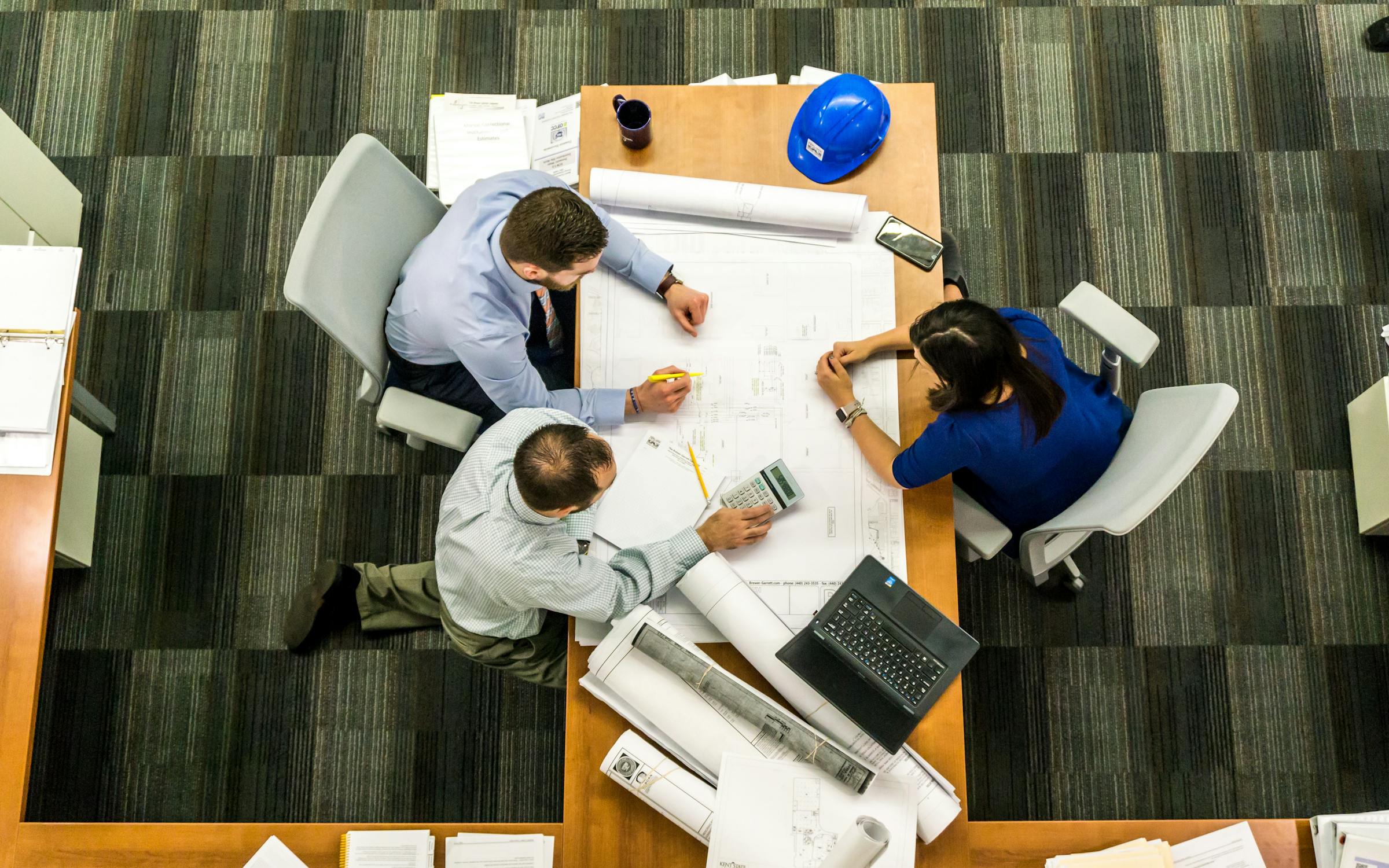 people sitting across a table planning a project